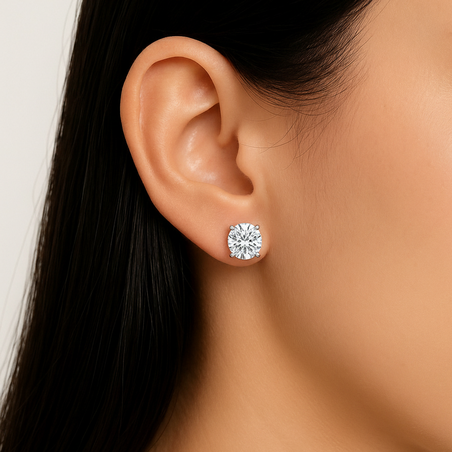 Round cut moissanite stud earring on ear close-up view