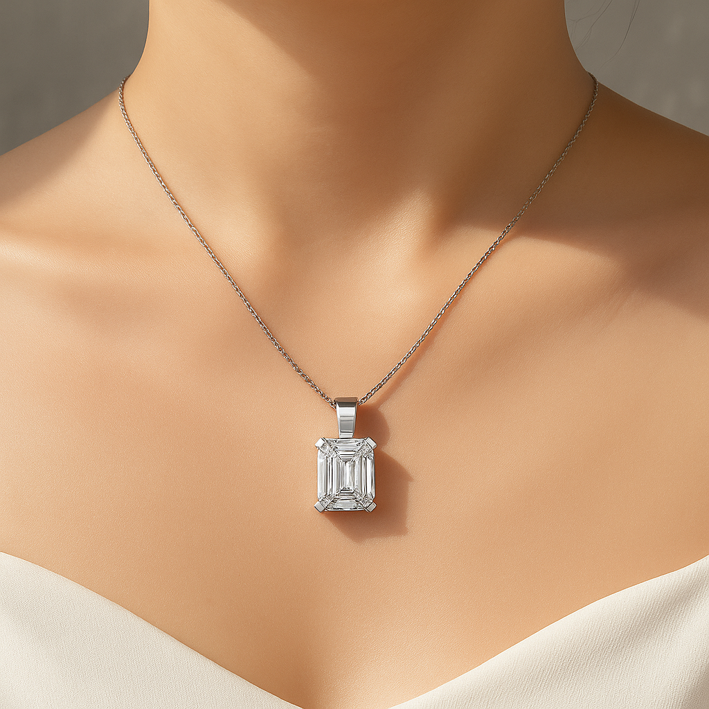 Emerald cut moissanite pendant necklace close-up on model’s neckline