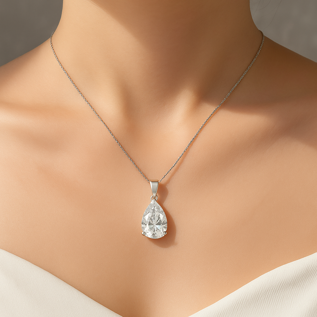 Pear cut moissanite pendant necklace worn around neck close-up view
